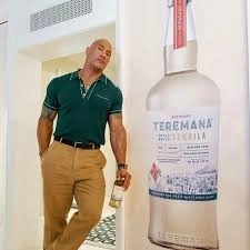 Unpacking The Rock’s “Synergy”: A Deep Dive Into Why He Puts His Face on Everything from Tequila to T-Shirts